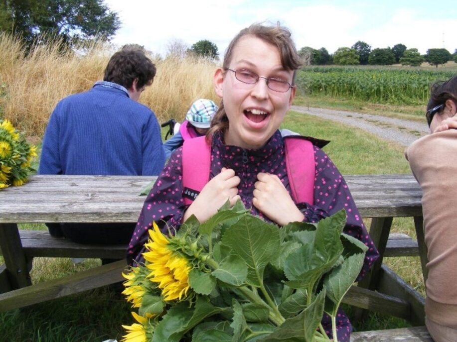 Cassie outside with sunflowers