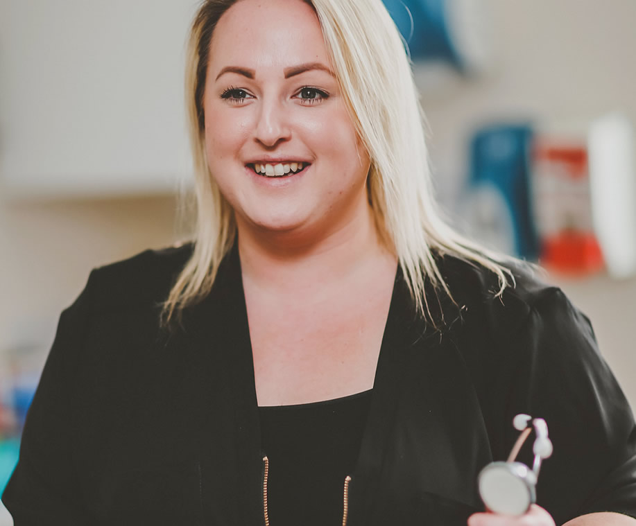 Nurse smiling and holding a stethoscope