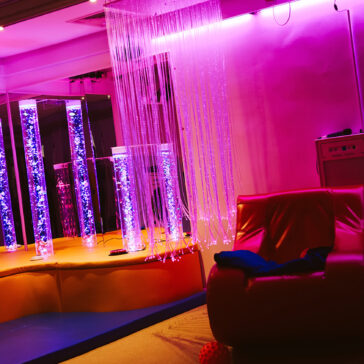 Sensory room with bubble tubes, soft-play flooring and purple lighting