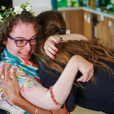 Young lady in a wheelchair hugging another lady