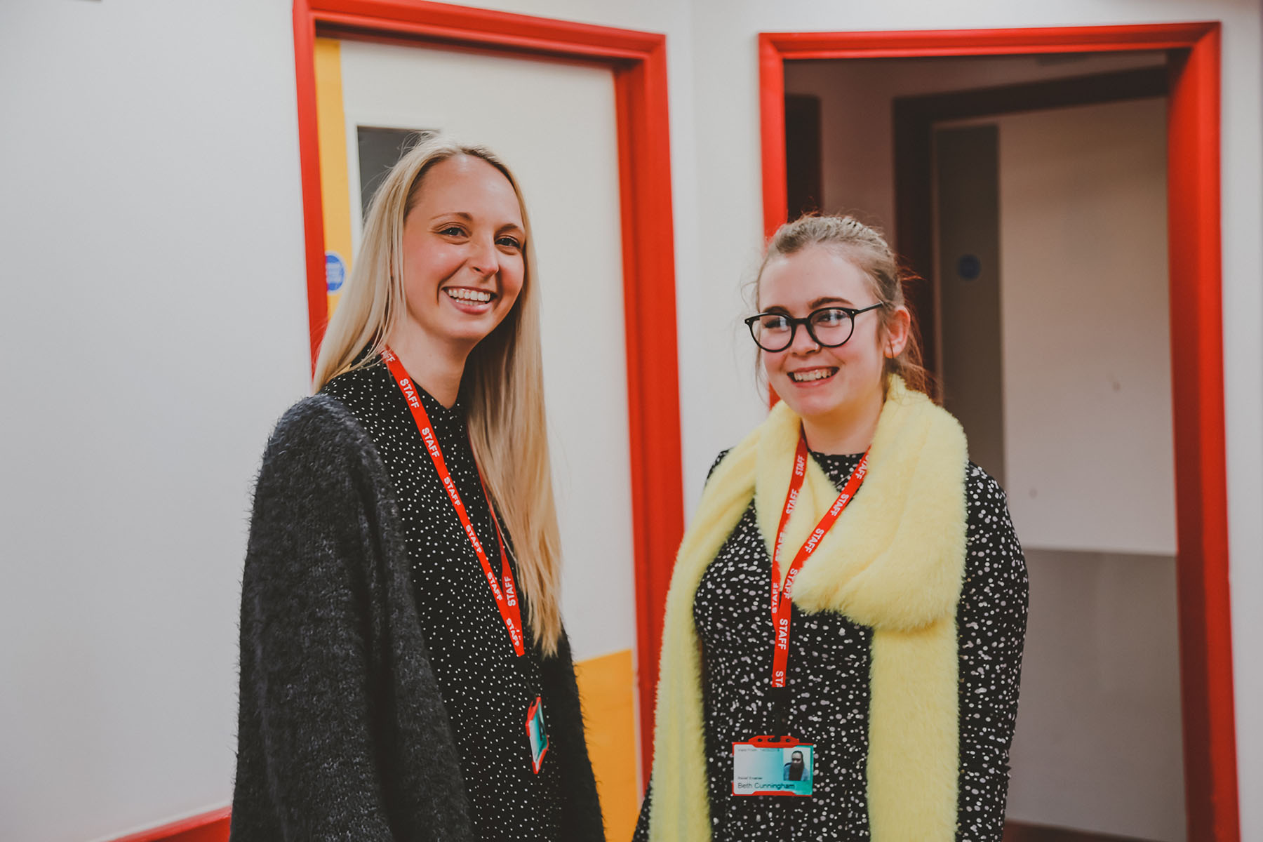 Two female members of staff stood next to each other smiling
