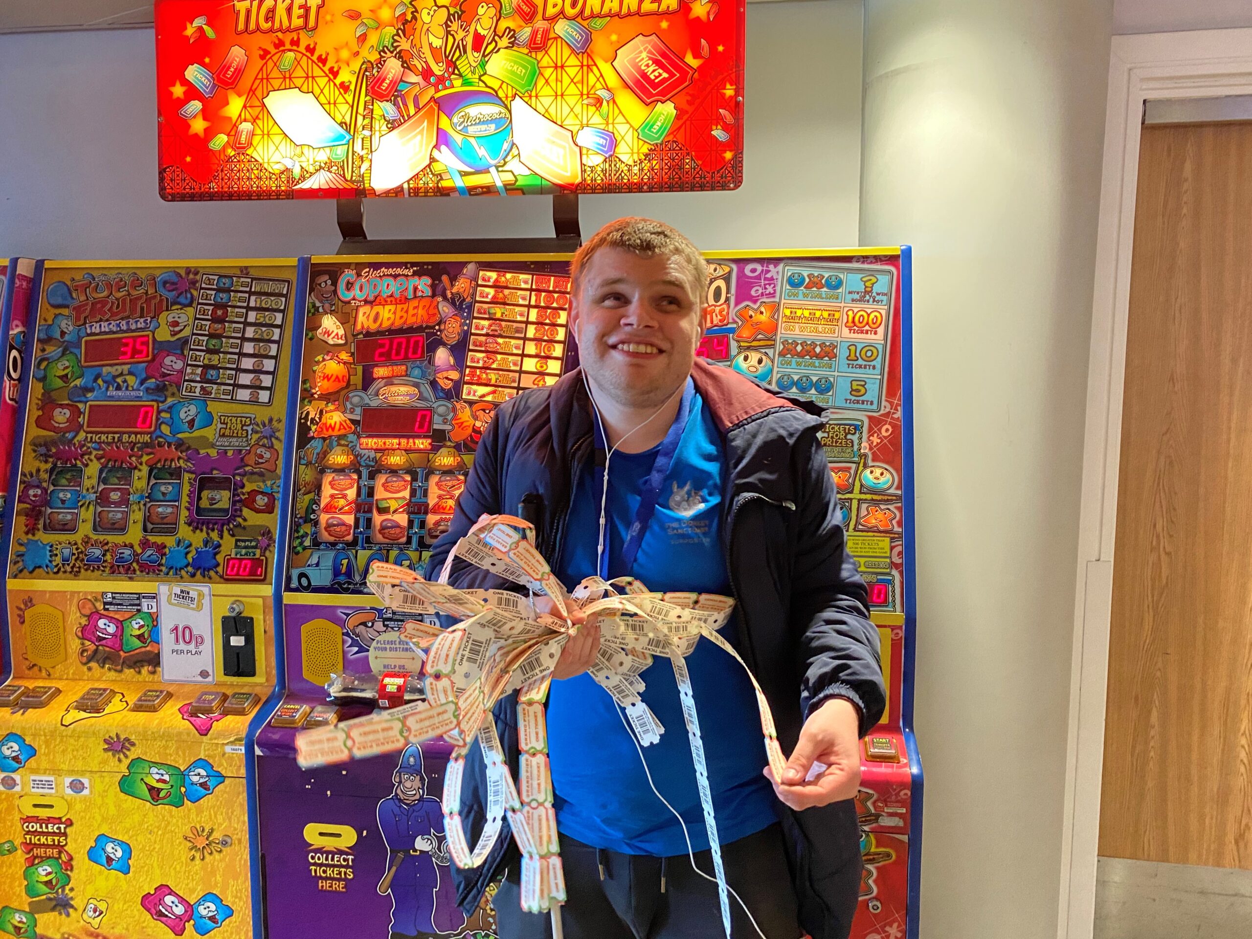 George holding his winnings from the slot machine