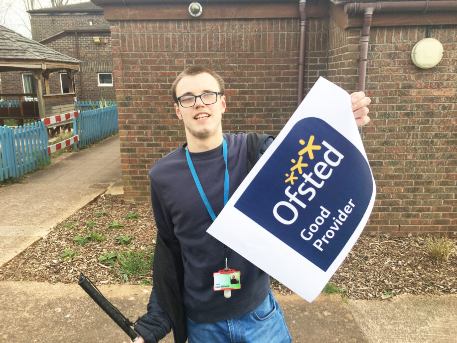 A student holding an Ofsted sign