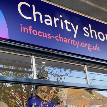 Charity Shop window and sign with InFocus website