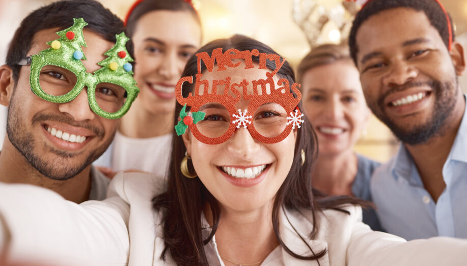 Portrait of a group of businesspeople taking selfies together during a Christmas party at work