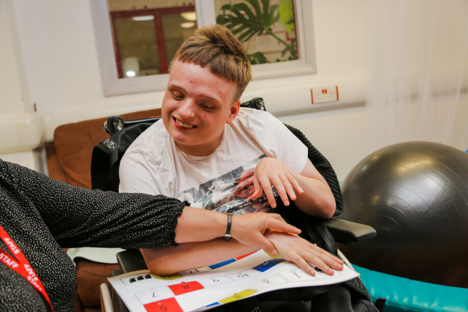 A young man in a therapy session - learning to communicate through symbols.