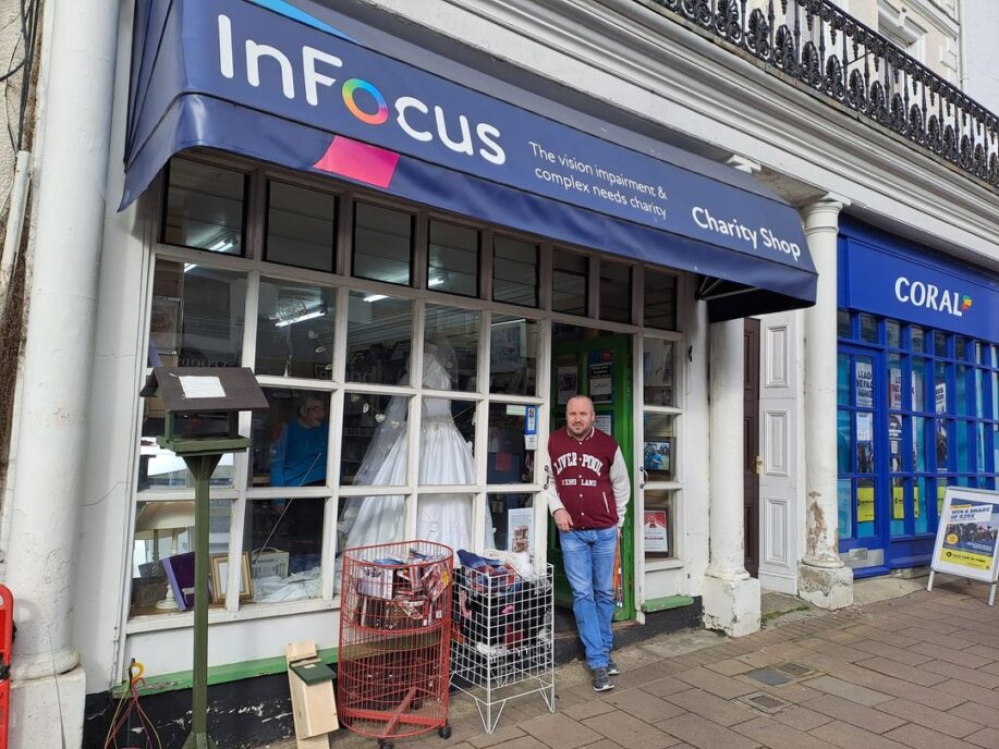 Man stood outside an InFocus charity shop