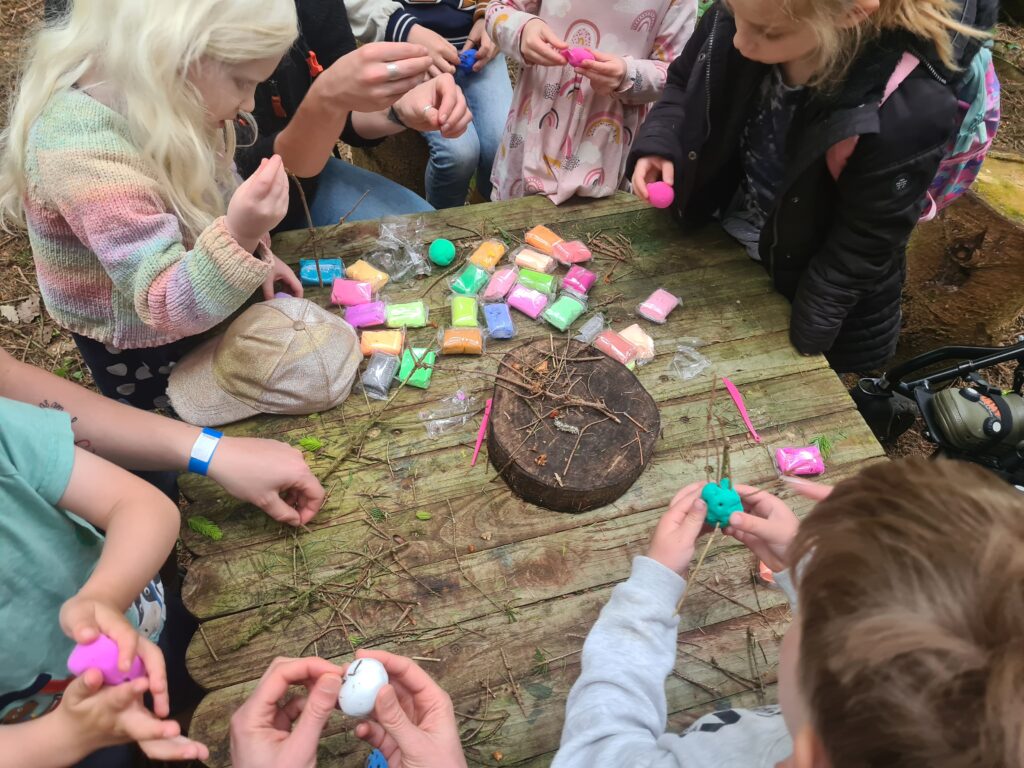 A table with lots of packets of colourful clay.
