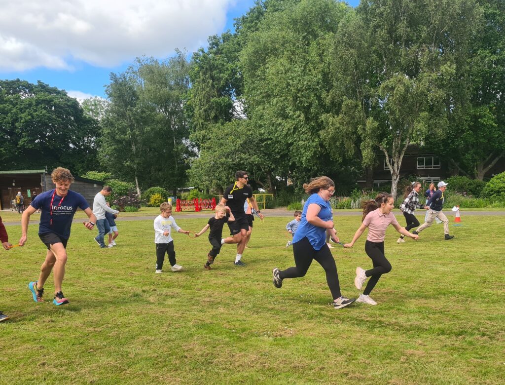 children and adults run in a race