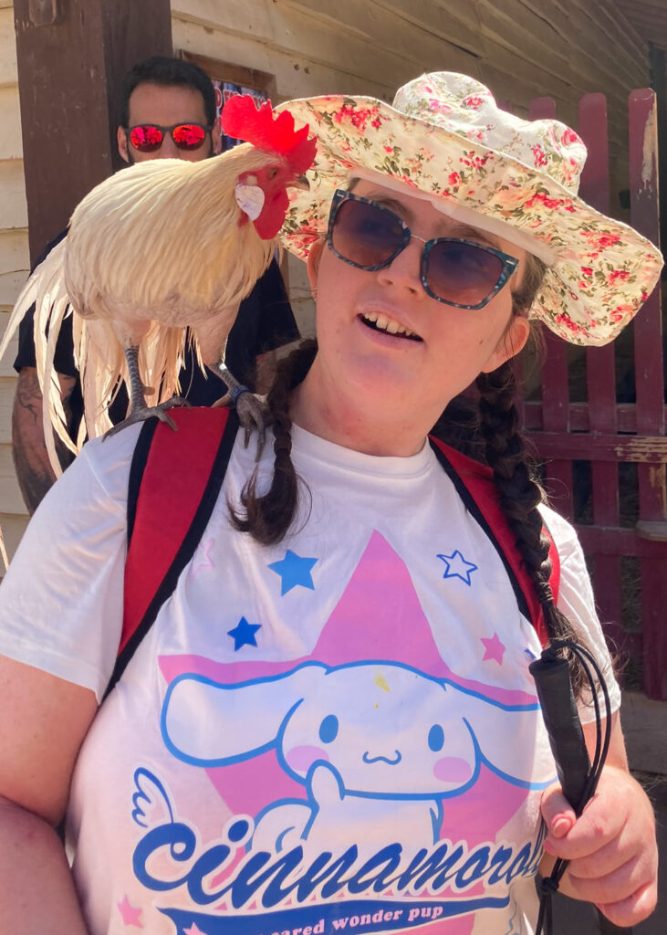 Young woman with a cockerel on her shoulder
