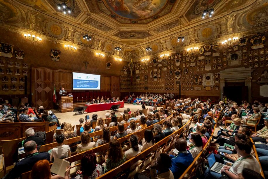a grand lecture theatre full of people