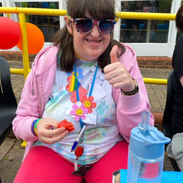 a student with her thumb up