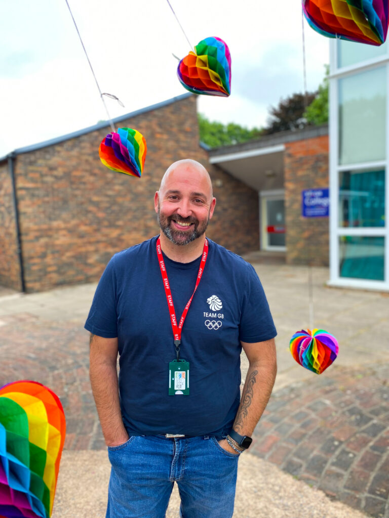 a staff member surrounded by colourful hanging objects