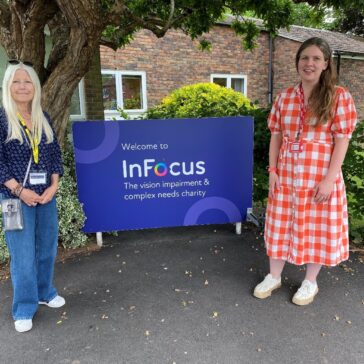 Two women standing next to the InFocus entrance