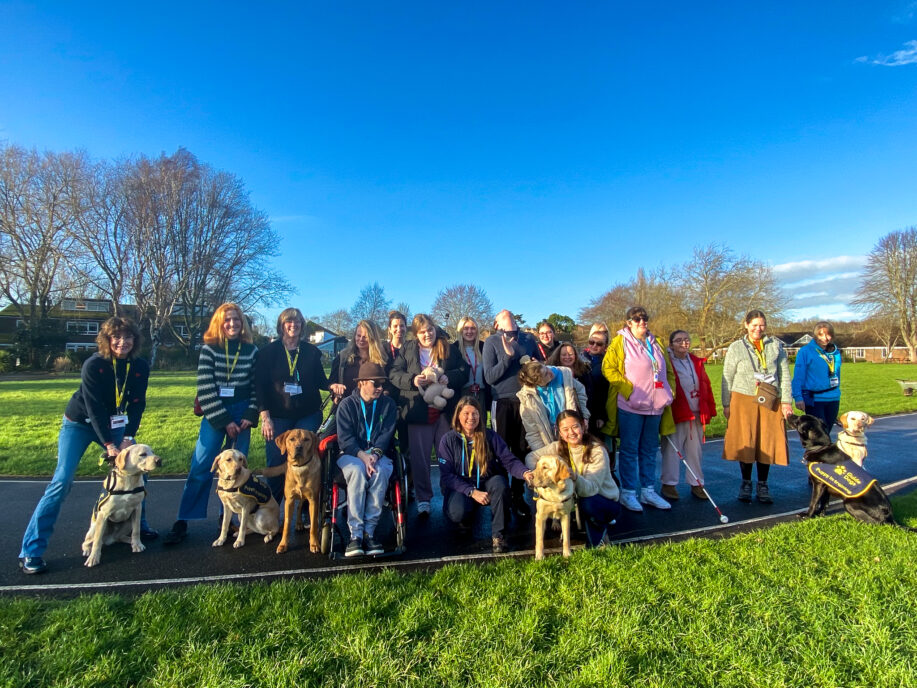 A group photo of students, Guide Dogs, volunteers and staff.