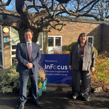 Steve Race MP and Jane Dye CEO of InFocus stood infront of an InFocus sign