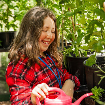 A young woman watering plants