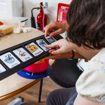 Communication buttons all to do with cooking. A finger is pointing a the word mix.