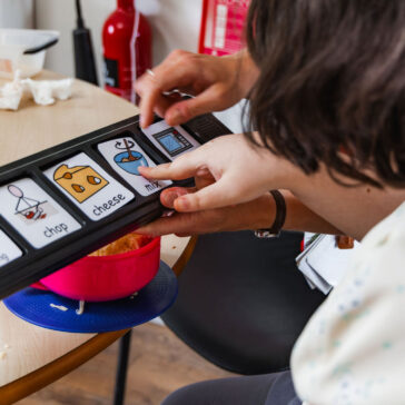 a close up photo of someone pointing towards a switch communication device.