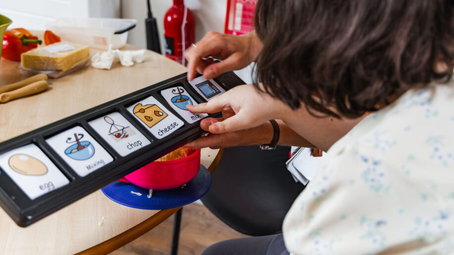 a close up photo of someone pointing towards a switch communication device.